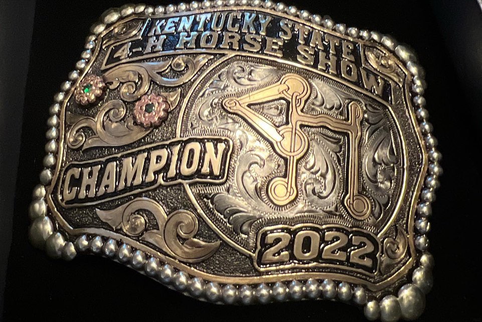 A close-up of the Kentucky State 4-H Horse Show Champion 2022 belt buckle.