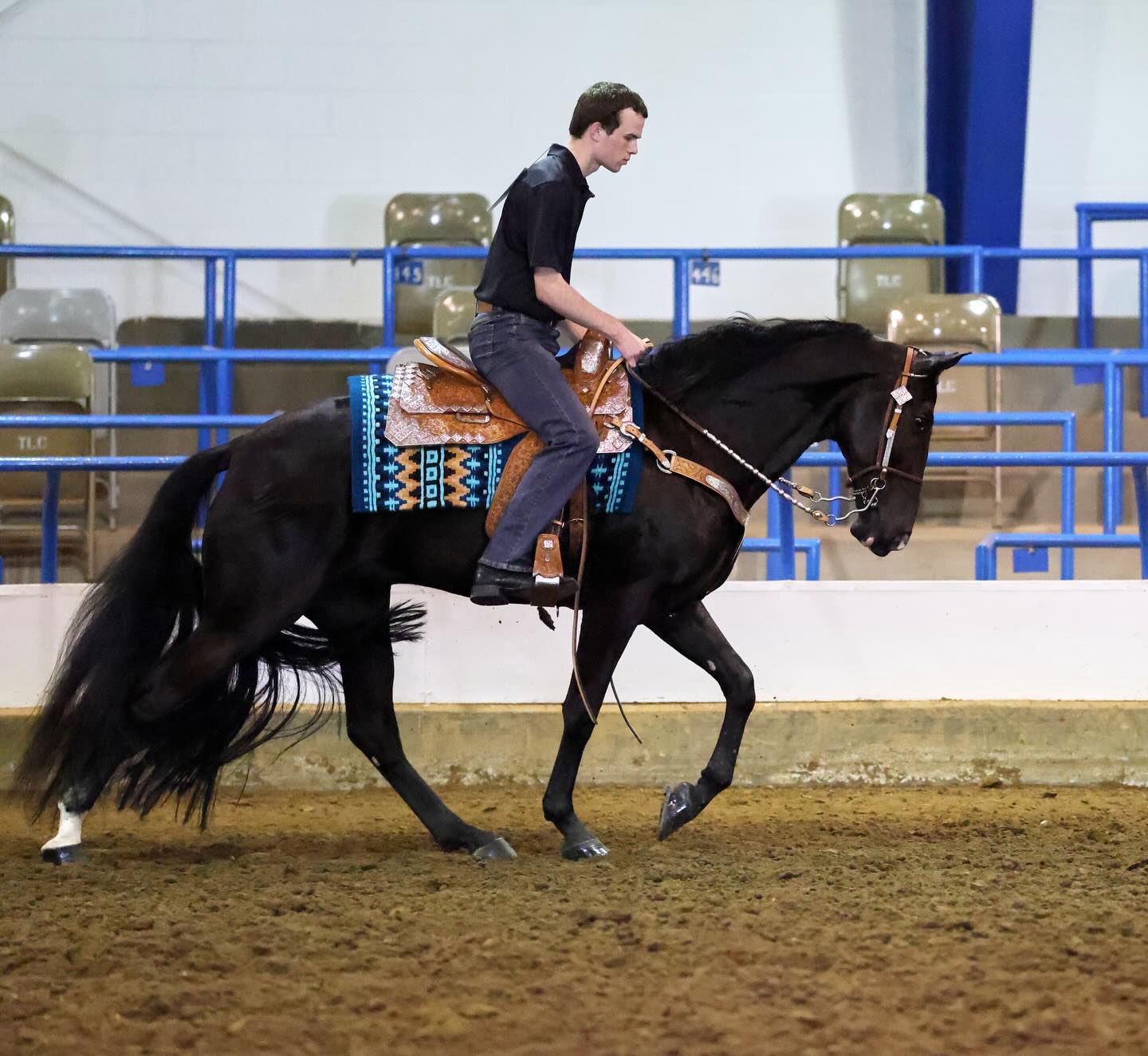 Kaleb and John Wick in the show arena, empty seating behind.