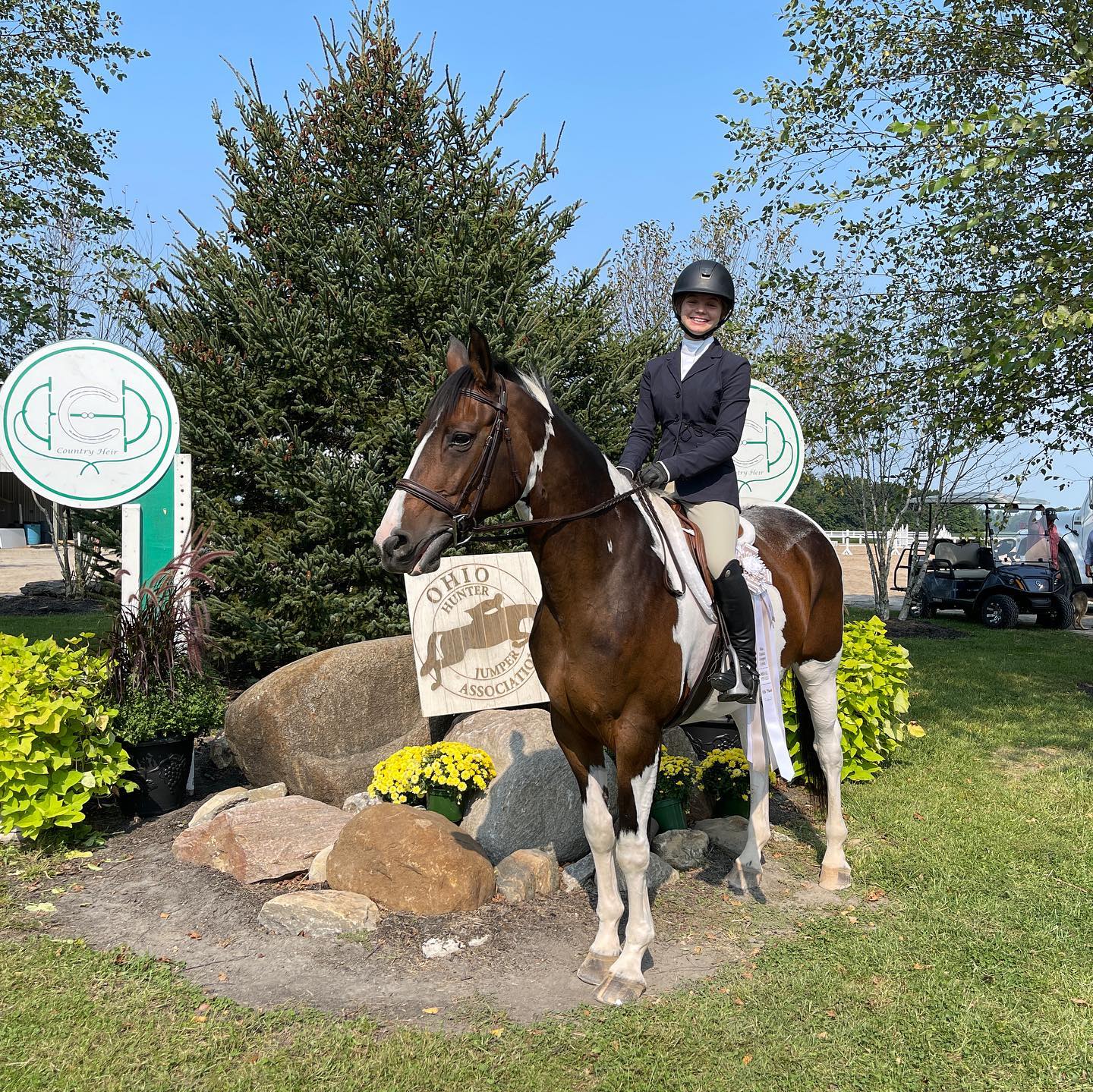 Rylee on SiSi with a ribbon in the Ohio Hunter Jumper Association winners circle.