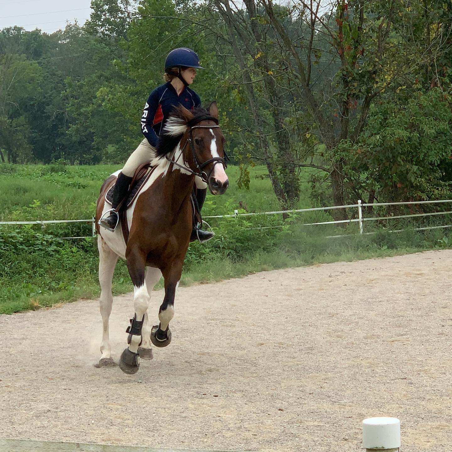 Rylee schooling SiSi at the canter in the outdoor ring.