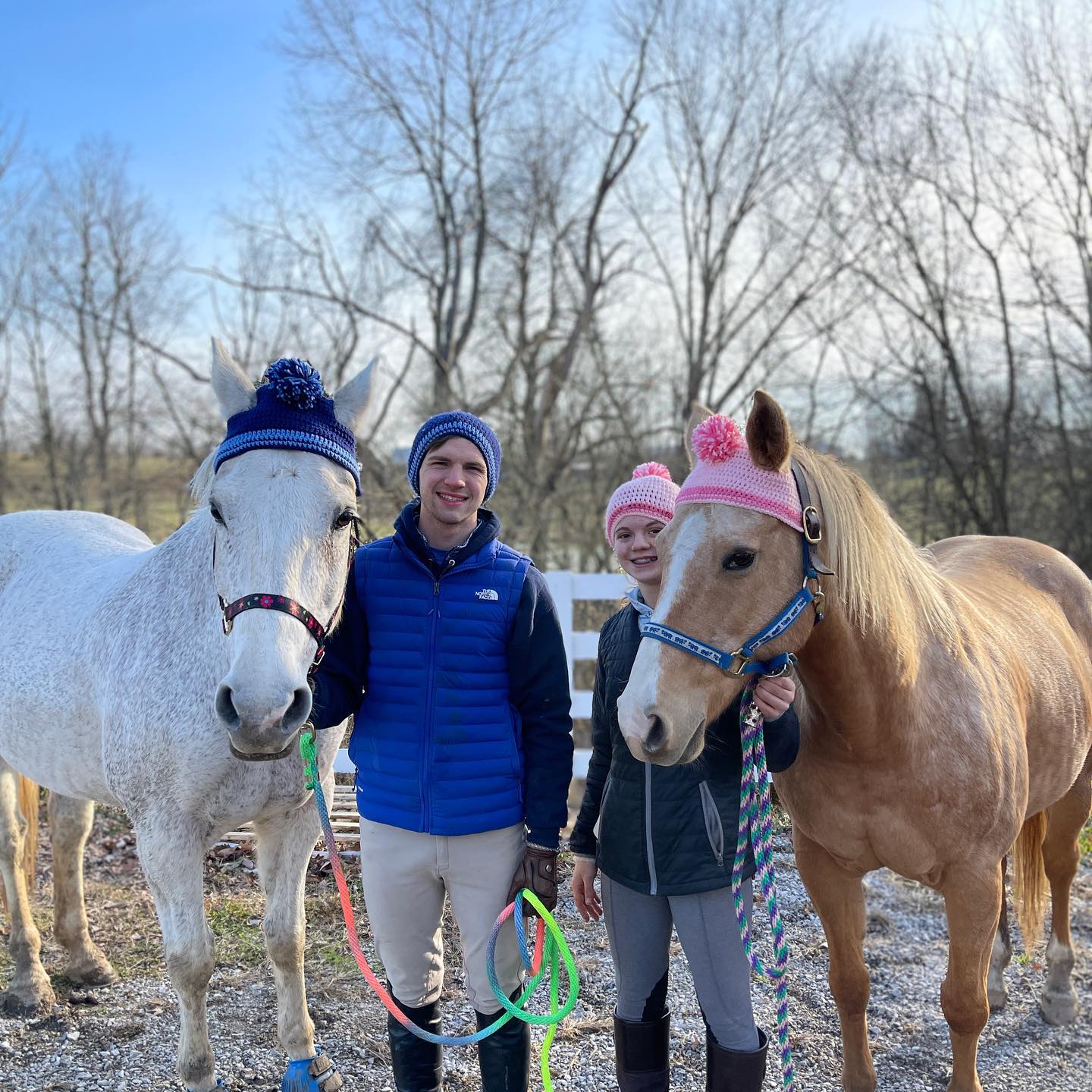 Snowflake in a blue pom hat and Carrie Virginia in a pink pom hat with Rylee and Kaleb for a winter photo.