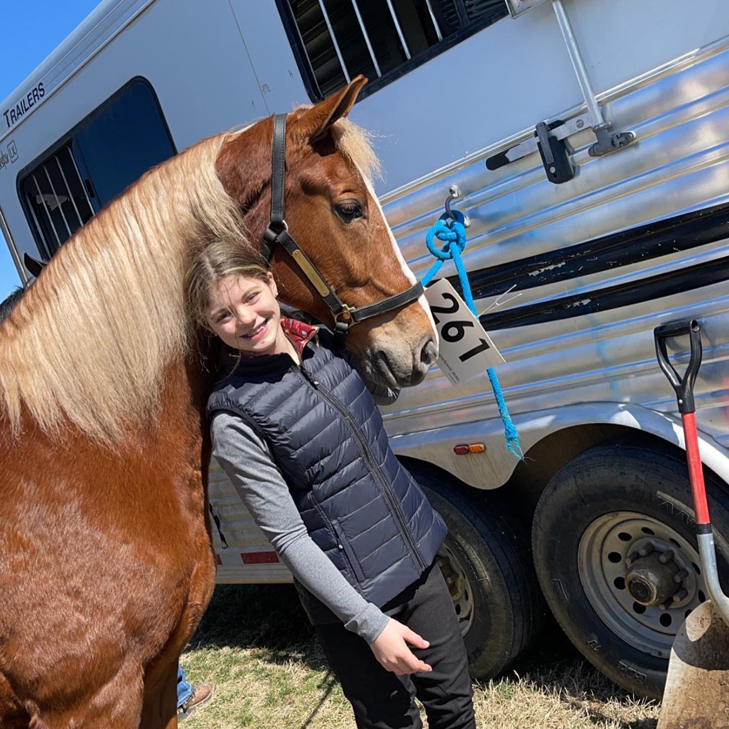Sonny wearing entry number 261 at the trailer with Rylee beside him.