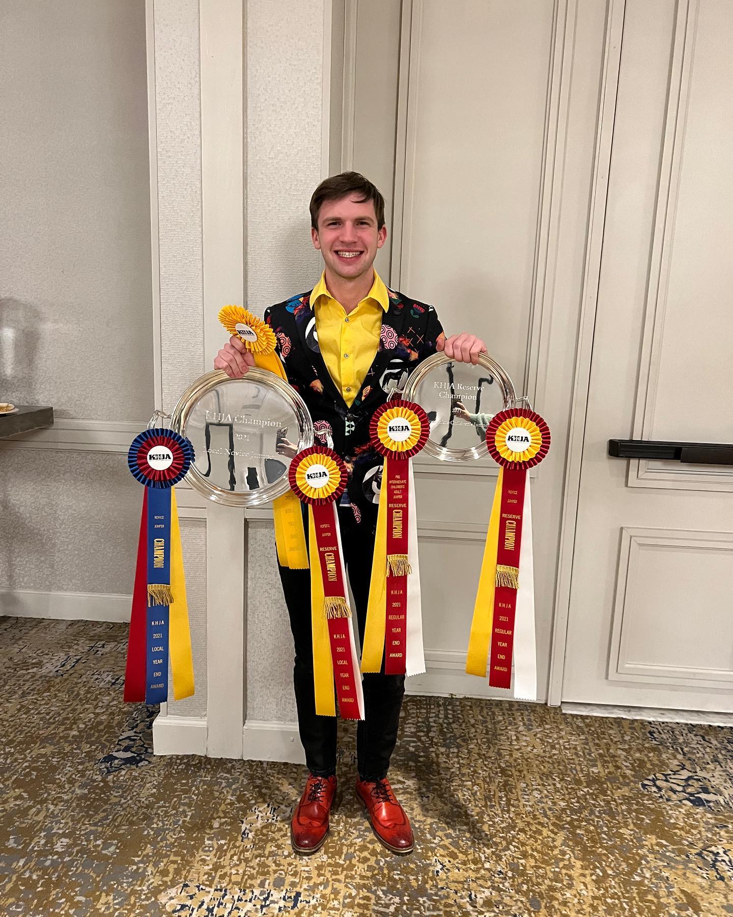 Kaleb with KHJA champion and reserve champion trays and rosettes at the awards banquet.