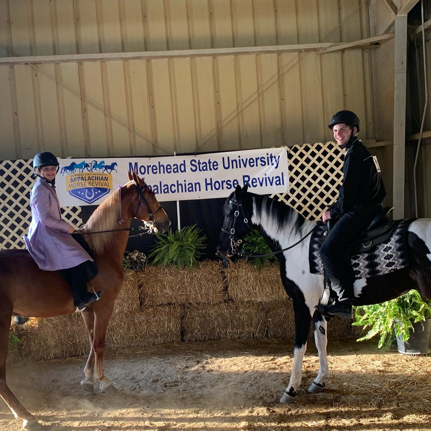 Kaleb and Rylee both mounted and smiling before the Morehead State Appalachian Horse Revival banner.