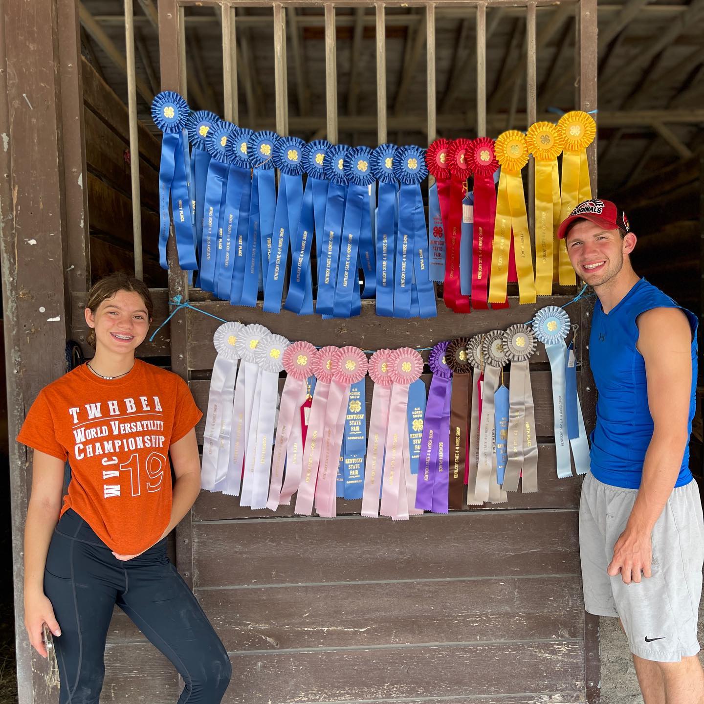 Rylee and Kaleb flanking a huge Kentucky State Fair 4-H ribbon display.