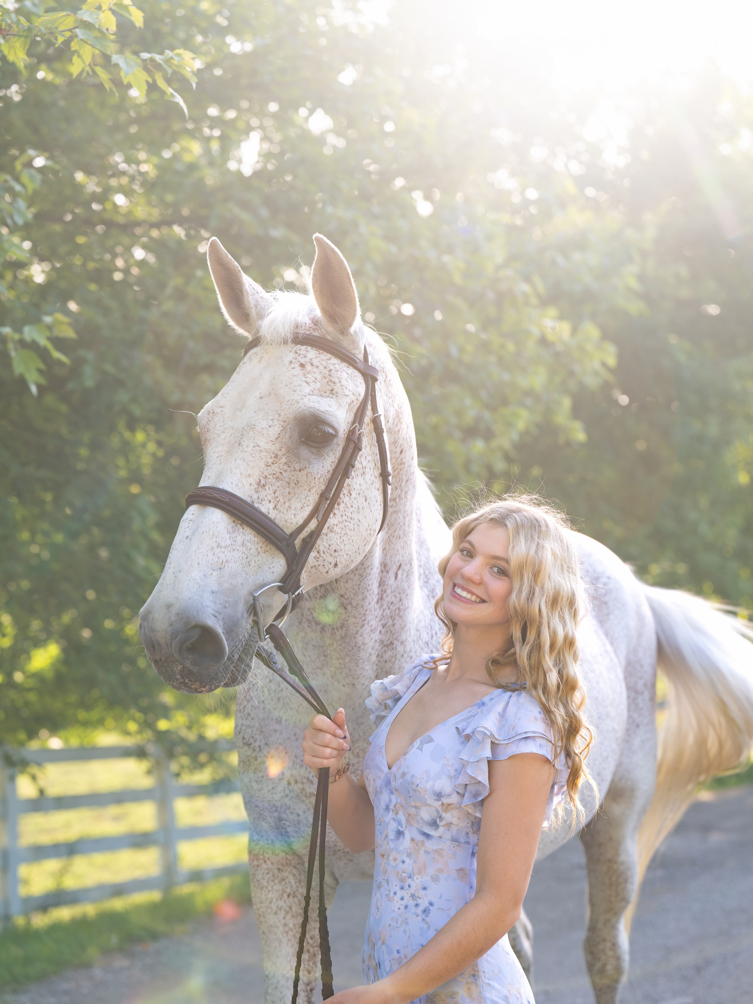 Rylee showing a bay mule with a red polka-dot browband in-hand in a sharp arena shot.