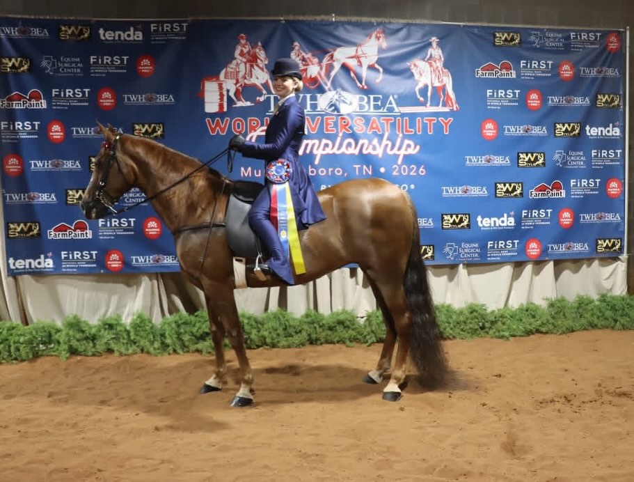 Rylee's win photo before the TWHBEA World Versatility Championship 2026 backdrop with a chestnut Walking Horse.